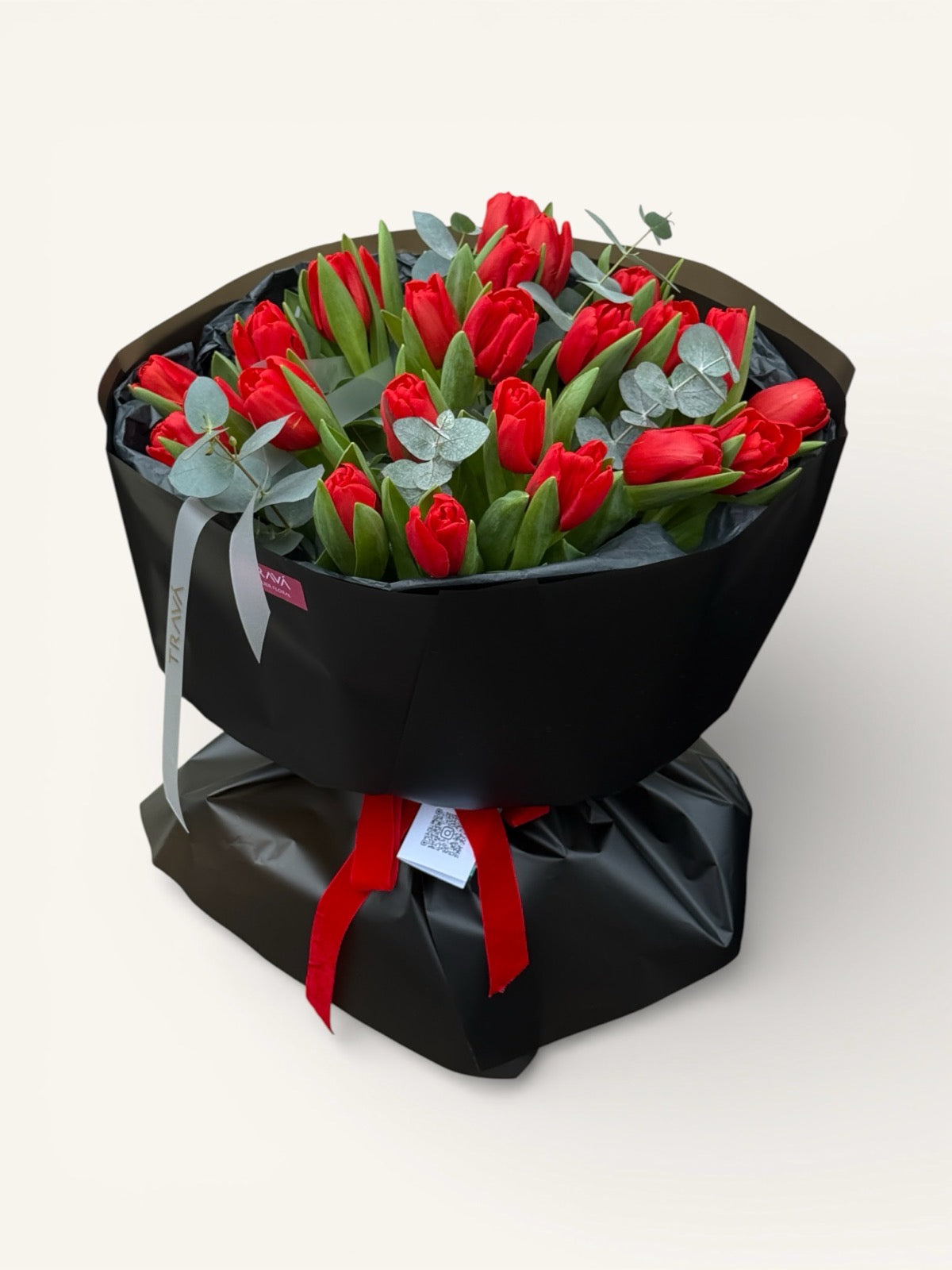 Buchet de lalele rosii si ramuri de eucalipt invelit in hartie neagra si legat cu panglica Trava Oradea. Livrare flori la domiciliu gratis.